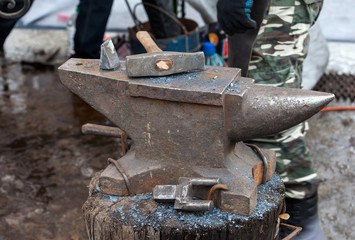 Old anvil with blacksmith tools on the outdoors