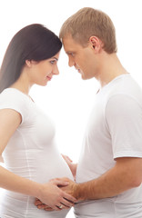 Fototapeta premium Young attractive couple: pregnant mother and happy father