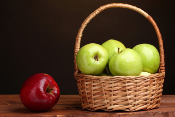 juicy green apples in basket and red apple