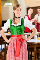 Young people in traditional Bavarian Tracht in restaurant or pub