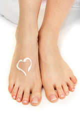 Beautiful woman legs with cream, isolated on white