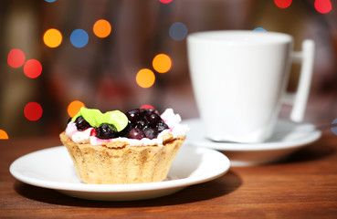 Tasty blackberry cake and cup of beverage,