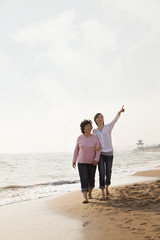 Grandmother and Granddaughter Taking a Walk by the Beach