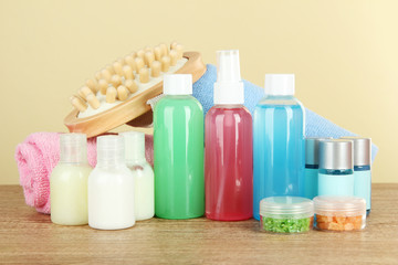 Hotel amenities kit on table on beige background