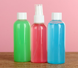 Hotel amenities kit on table on pink background