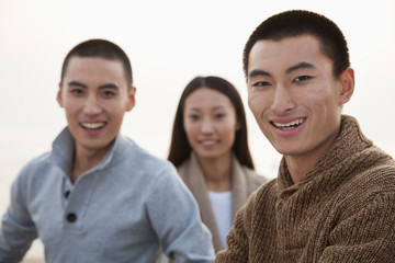 Young Friends Sitting on the Beach
