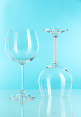 Two glasses on light blue background