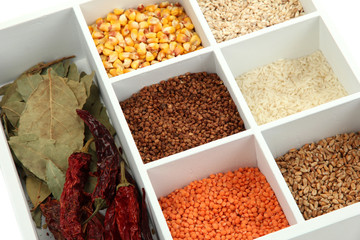 Assortment of cereals in white wooden box close up