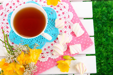 Beautiful composition with cup of tea and marshmallow