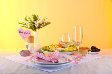 Table setting on yellow background