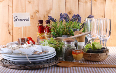 Table setting on checkered tablecloth on wooden background
