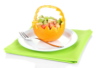 Fruit salad in hollowed-out orange isolated on white