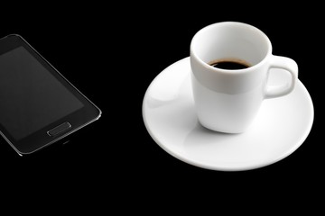 Fototapeta na wymiar black smartphone and cup of coffee
