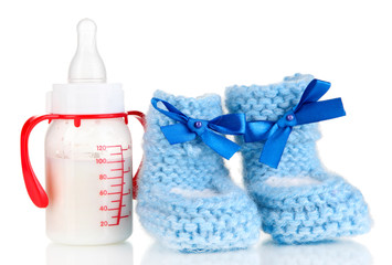 Bottle for milk formula with booties isolated on white