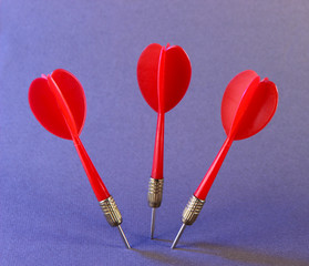 Darts on purple background