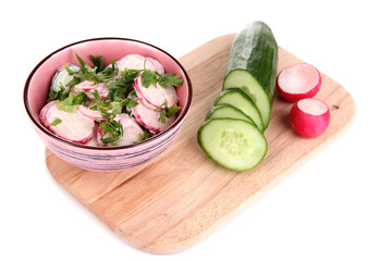 Vitamin vegetable salad in bowl with ingredients isolated