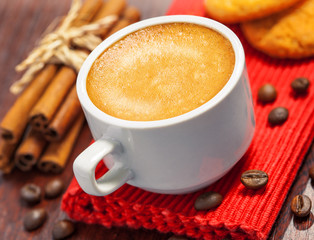 Coffee cup, cookies and cinnamon on a table