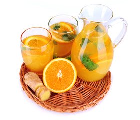 Orange lemonade in pitcher and glasses isolated on white