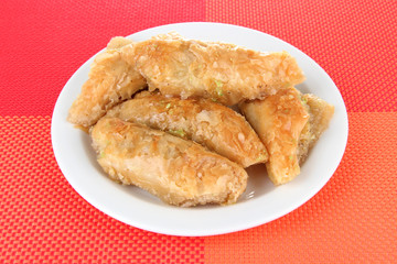 Sweet baklava on plate on table