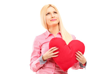 A woman holding a red heart