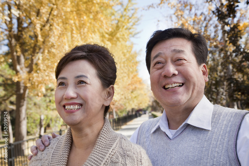 Happy Mature Couple Enjoying the Park in Autumn