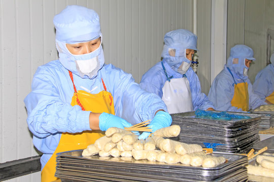 workers in the food processing production line in a factory
