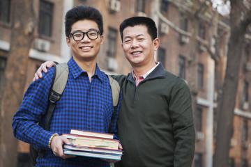 Father and son portrait in front of dormitory