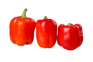 Three ripe red peppers isolated on white
