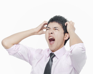Young man with hands on head screaming
