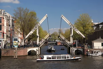 Poster Amsterdam with boat against old bridge in Holland © Tomas Marek