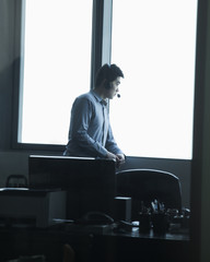 Man looking through window in office