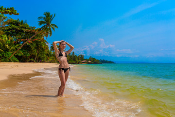 Fototapeta na wymiar Girl on a tropical beach