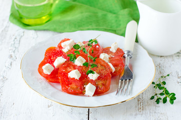 Salad from fresh tomatoes and cheese Fett with thyme