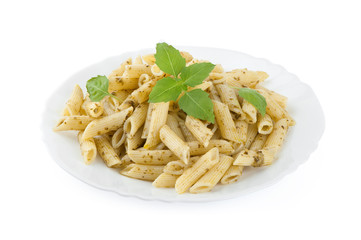 Pasta with pesto sauce and fresh basil on white plate