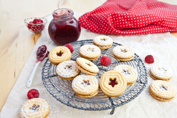 Jam-filled cookies and raspberries