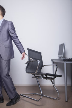 Businessman Handcuffed To His Office Chair, Walking Away