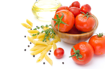 fresh tomatoes, pasta penne, olive oil and spices on white