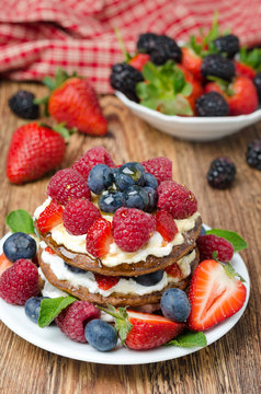 Pancake cake with whipped cream and fresh berries