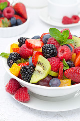 salad of fresh fruit and berries in a white bowl