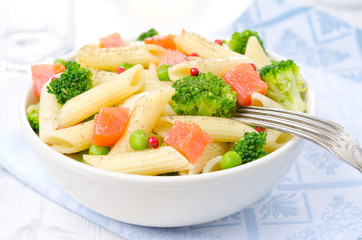 bowl of salad with pasta, smoked salmon, broccoli,  green peas