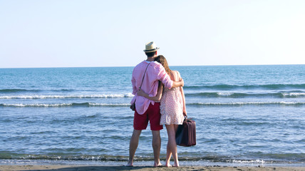 A cheerful couple fooling around on the beach