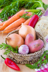 Potatoes, onions, carrots in the basket - new harvest