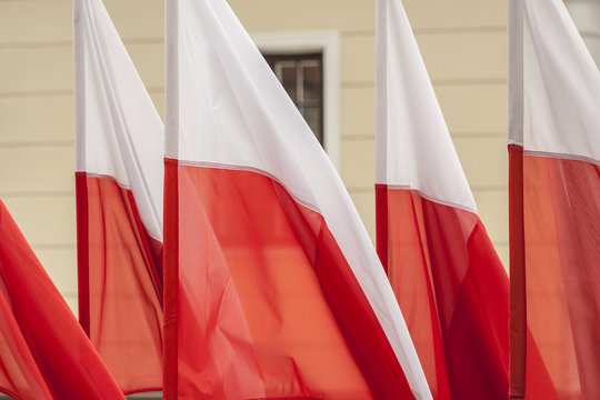 Polish flags on a background of wall.