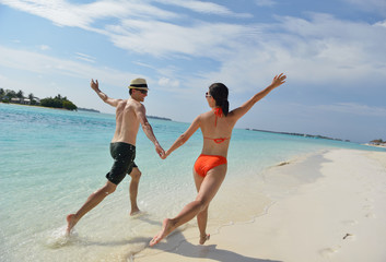 happy young couple have fun on beach