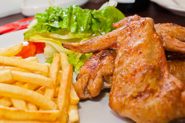 Fried chicken wings with fries