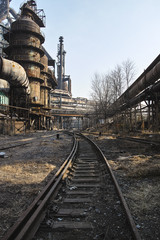 Fototapeta premium Rusted railway and abandoned steelmaking equipments