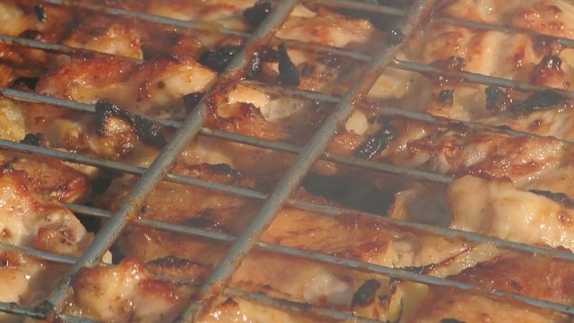 Close-up shot of chicken wings on barbeque outdoors