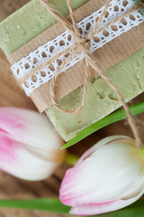 Spa setting with hand made soap and pink tulips
