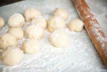 Fototapeta na wymiar Prepared dough in ball shape on silver tray