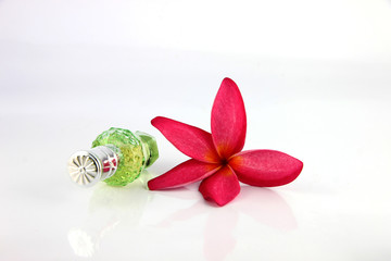 Red flowers and Green Perfume bottles.